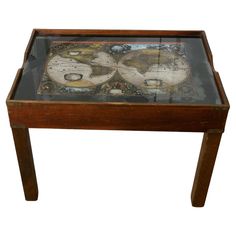 an old wooden table with a glass top