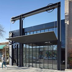 an empty building with glass doors on the front and side of it's entrance