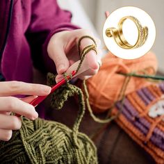 a woman knitting yarn with a pair of scissors