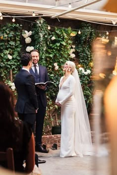 a bride and groom standing at the alter during their wedding ceremony