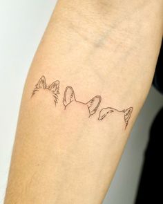 three cats tattoo on the left arm