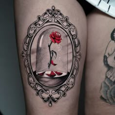 a couple of tattoos on their legs that have roses in the hour glass and a red rose