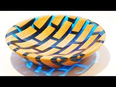 a wooden bowl sitting on top of a white table