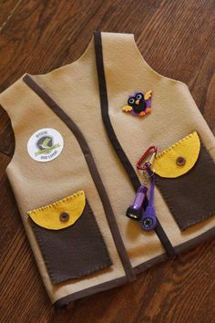 a child's vest made out of felt with buttons on the front and sides