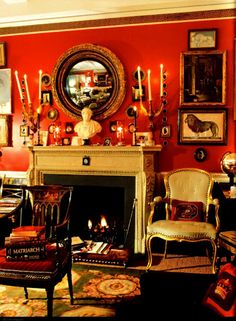 a living room filled with furniture and a fire place in front of a mirror on the wall