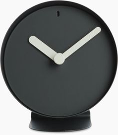 a black clock with white hands is shown