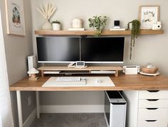 a computer desk with two monitors, keyboard and mouse on it in a home office