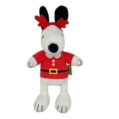 a white stuffed dog wearing a red shirt and reindeer antlers on it's head