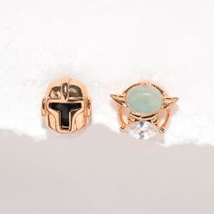 Inspired by the hit Star Wars™ series comes the Star Wars The Mandalorian™ & Grogu™ Studs. This dynamic duo will become your go-to pair. The Mandalorian stud is sleek and showcases his signature armor, while the Grogu stud offers a bright, milky, mint green stone. Earrings Double Piercing, Double Piercing Earrings, Star Wars Jewelry, Dinosaur Earrings, Double Piercing, Earrings Double, Piercing Inspo, Piercing Earrings, Flat Back Earrings