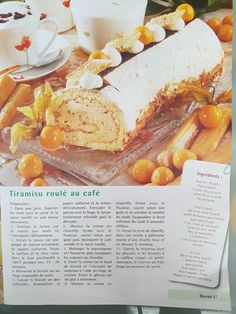 an article in a magazine about food and drink on the table with oranges around it