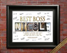 the word best boss written in different languages on a brick wall with a gold ribbon