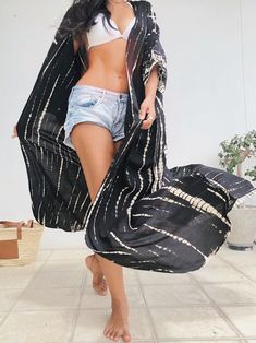 A beautiful unisex kimono, the Maya Tie Dye Kaftan Kimono is handcrafted from 100% soft rayon and features side slits at the hemline and inner loops between wings complemented by breezy sleeves, a basic for remaining cool as temperatures soar. Slip the chic kimono robe over a bikini or part with our Maya boho pants for a look that incorporates luxury style. Features: Handcrafted, Hand tie-dye Maxi length Very comfortable Breathable Removable waist tie closure No sleeves and No pockets as Kaftan Bohemian Black Long Robe, Bohemian Long Black Robe, Long Black Bohemian Robe, Black Long Bohemian Robe, Black Bohemian Robe With Kimono Sleeves, Bohemian Black Robe With Kimono Sleeves, Black Bohemian Kimono For Beach Cover-up, One Size Wrap Kaftan For Festival, Wrap Kaftan For Festivals