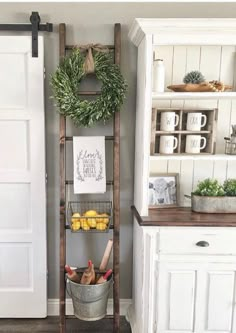 an old wooden ladder is used as a shelf for fruit and vegetables in the kitchen