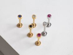 HYPOALLERGENIC & WATER-RESISTANT ∙ THESE TINY 3MM CARTILAGE EARRINGS WILL LOOK FABULOUS ON YOUR TRAGUS, HELIX, FORWARD HELIX, CONCH AND EARLOBE PIERCINGS ✦ PRODUCT DETAILS ✦ * Listing for Single Piece * Hypoallergenic ∙ Water-Resistant Earring * Materials: 14k Gold ∙ Rose gold ∙ Silver on Brass with Cubic Zirconia 316L Stainless Steel Post * Earring Size: Appx 3mm ✦ POST THICKNESS ∙ TYPE GUIDE ✦ * Thicknesses (gauge)   16g (thickest)   18g   20g (thinnest) * Backing Type   Threadless (Pushback) ✧ Head Only NO POST option is compatible with any of our shop's threadless backings regardless of gauge ✦ ADDITIONAL BACKINGS ✦ * If you'd like extra backing sizes as an add-on, you can find them here: https://etsy.me/2Rrgwud ✦ PACKAGING & SHIPPING ✦ * All Origami Jewels orders are beautifully packa Origami Jewels, Helix Studs, Medusa Jewelry, Forward Helix Earrings, Helix Jewelry, Helix Earring, Forward Helix, Cartilage Earring, Helix Earrings