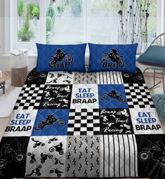 a bed covered in blue and black quilts