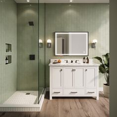 a bathroom with green walls and wooden floors