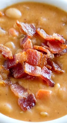 a white bowl filled with soup and bacon