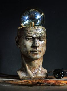 a statue with a glass ball on top of it's head