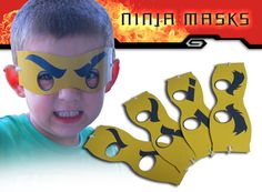 a young boy with his face painted yellow and black, has five masks in front of him