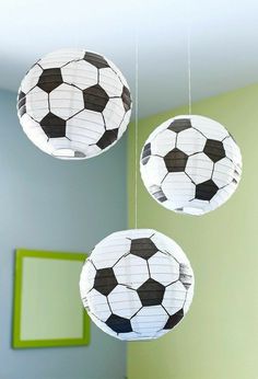 three paper soccer balls hanging from the ceiling