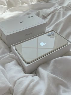 an iphone box sitting on top of a bed