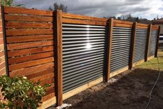 a wooden fence with metal slats on it