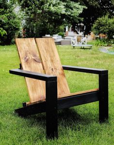 a wooden chair sitting on top of a lush green field