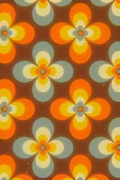 an orange, yellow and blue flower pattern is seen in this image from the 1960s's