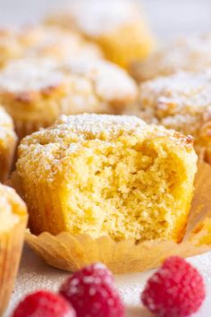 some raspberry muffins on a white plate with fresh raspberries