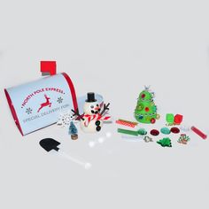 an assortment of holiday treats and decorations on a white surface