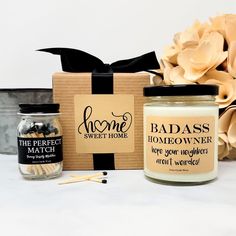 a candle, matches, and gift box sitting next to each other on a table