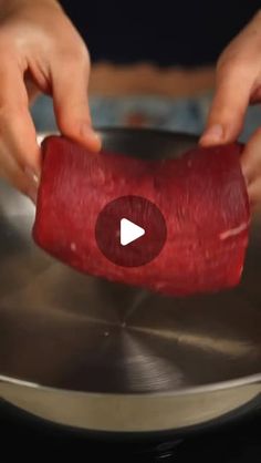 a video demonstrating how to cook raw meat in a pot with the help of two hands