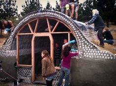 some people are building a house out of concrete and plastic bottle caps on the roof