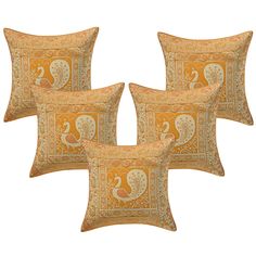 four pillows with an orange and yellow paisley pattern on the front, one has a white peacock