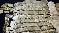 a pile of silver coins sitting next to each other