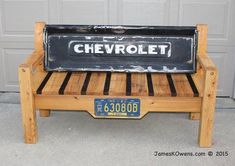 a bench made out of wood and metal with the word chevrolet on it's back