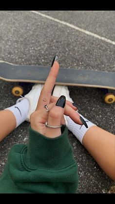 a person sitting on the ground with their fingers in the shape of a peace sign