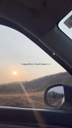 the sun is setting in the distance as seen from inside a car