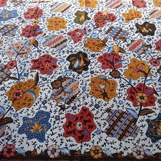 a large quilt with many different designs on it's sides and the bottom half