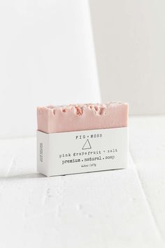 a pink bar of soap sitting on top of a white counter