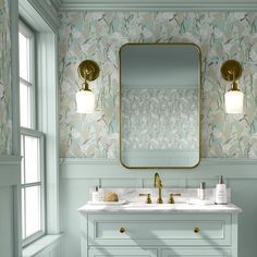 a bathroom vanity with two sinks and a large mirror above it, in front of a window