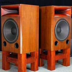 two wooden speakers sitting on top of each other