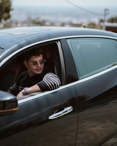 a man sitting in the driver's seat of a car