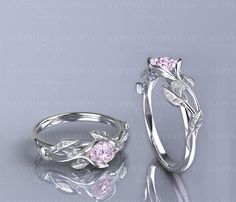 two wedding rings, one with leaves and the other with flowers on it's sides