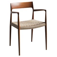 a wooden chair with woven seat and armrests on an isolated white background,