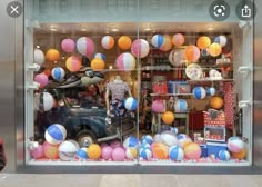 an image of a store window that has balloons in the front and on the outside