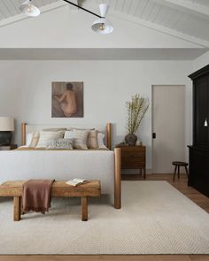 a bedroom with a large bed and wooden furniture