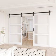 an open door leading to a bedroom with white walls and floor tiles on the floor