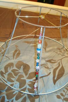 a metal rack with beads on it sitting on top of a table