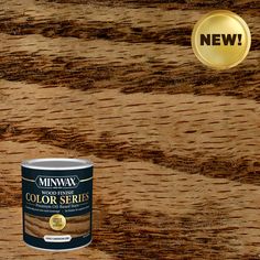 a can of minwax wood finish paint next to a gold seal on a wooden surface